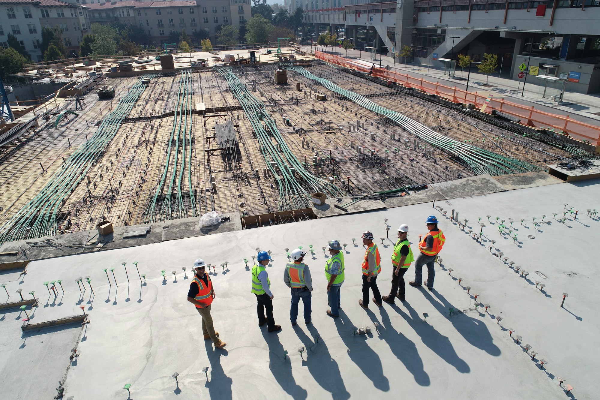 Construction and infrastructure works at golden hour — the field conditions AGS measures and certifies.